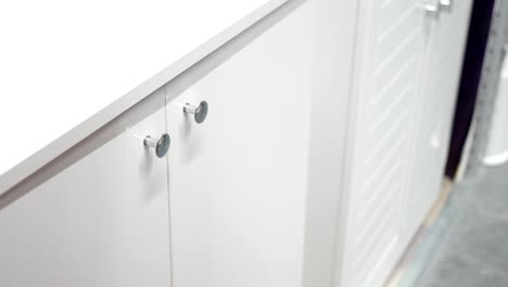 white kitchen cabinets with silver knobs