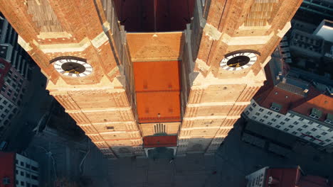 revealing aerial of the architectural marvel of munich frauenkirche, showcasing its two towering spires with awe-inspiring grandeur