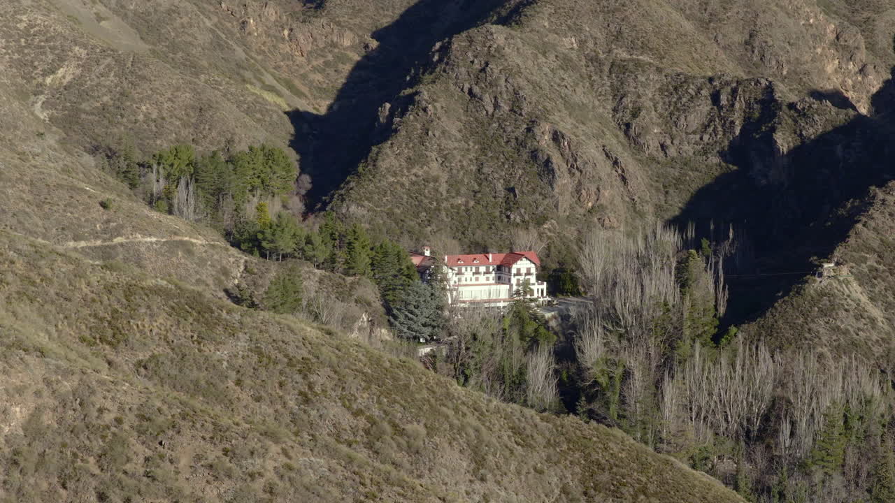 Gran Hotel Villavicencio, thermal spa landmark, stands surrounded by arid slopes and native trees within Mendoza’s Reserva Natural Villavicencio, a region famed for rugged beauty in Argentina