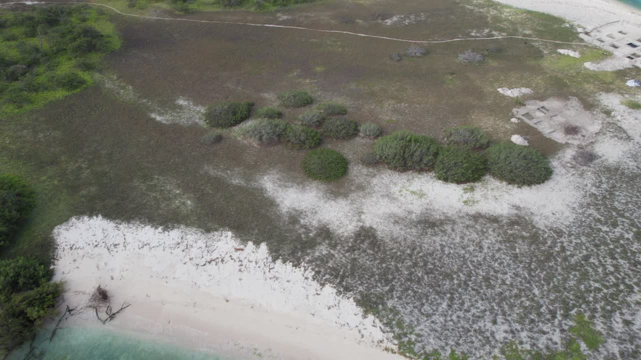 Aerial tilt up over turquoise waters at Los Roques, serene and tranquil view
