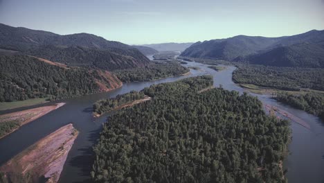 aerial view of a river winding through a forest valley