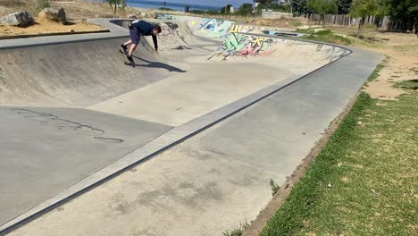 young skater doing tricks outdoors with surf skate model - carver