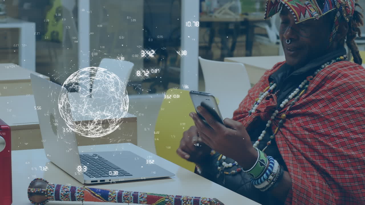 Animation of globe with numbers over smiling african american businessman using laptop