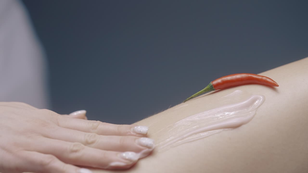 Applying Chili Pepper Cream to a Leg