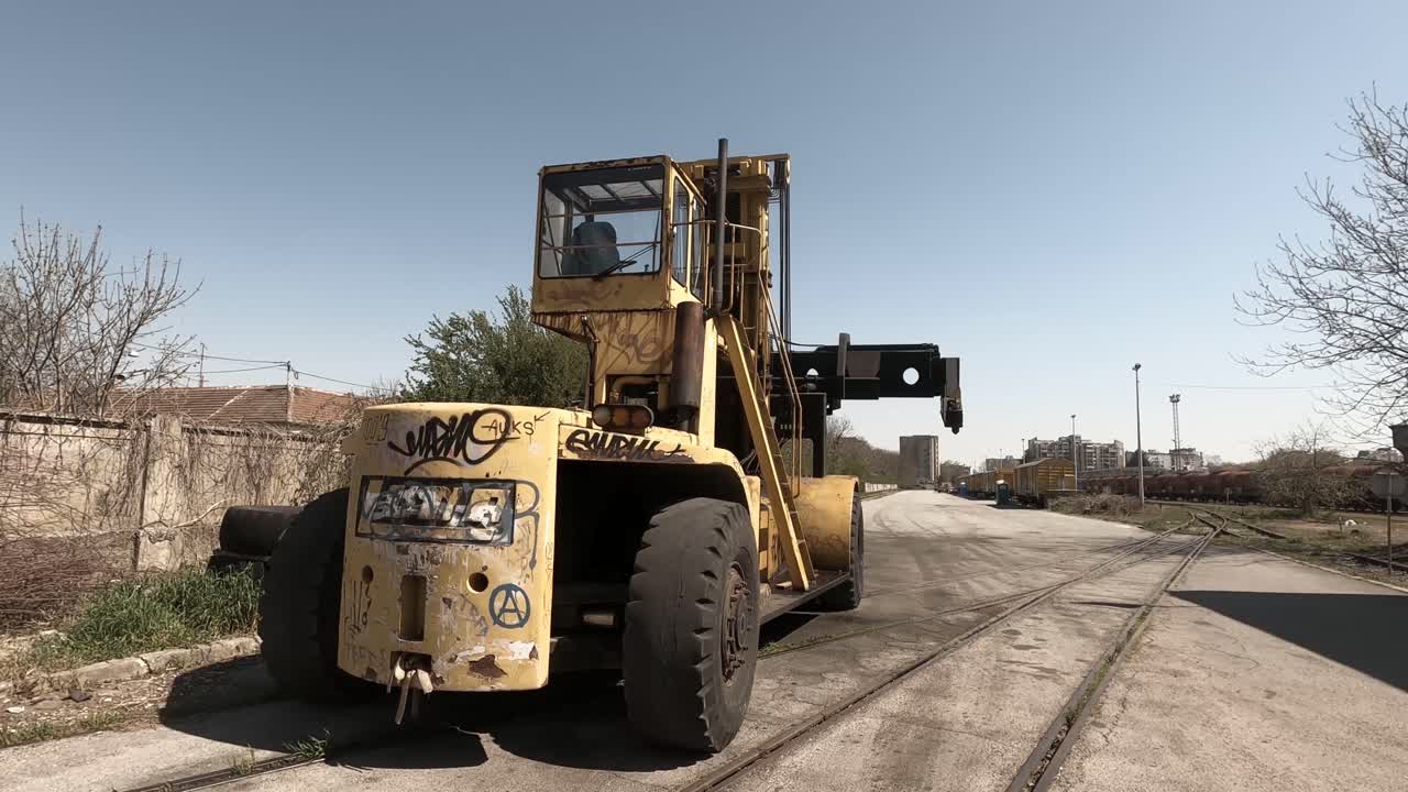 A huge yellow crane froklift in a train depot OSIJEK , CROATIA
