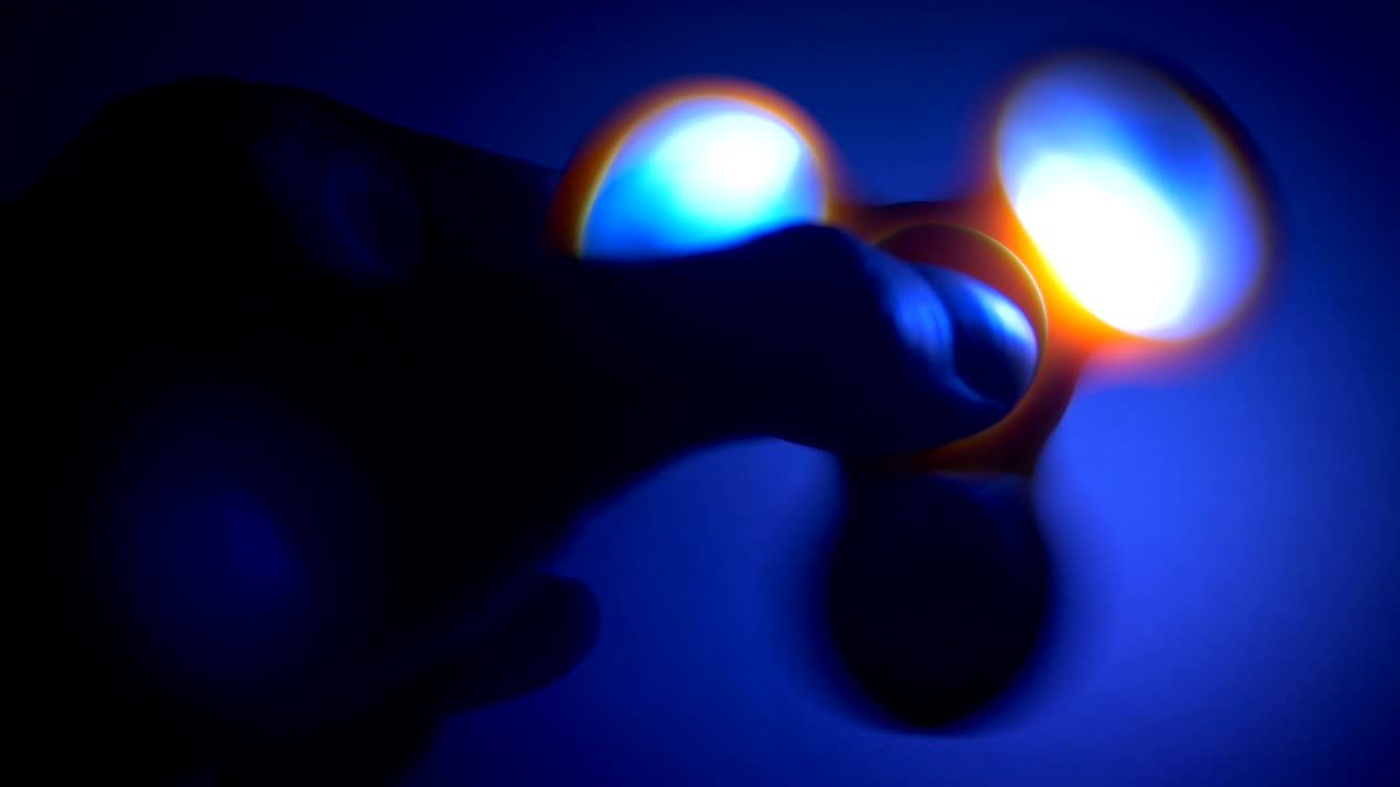 Fidget spinner with led light spinning in the dark.