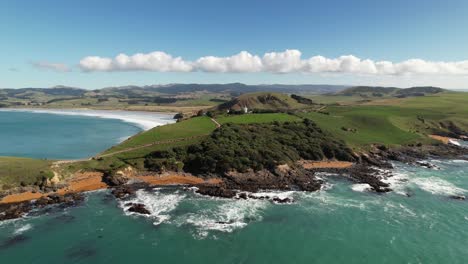 Aerial-panoramic-of-Katiki-Point-lighthouse,-historic-landmark-and-travel-destination,-New-Zealand