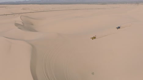 Sand-Dune-Adventurers,-Aerial-Drone-Footage-of-ATV-Off-Roaders-Driving-on-Sand-in-Glamis-California