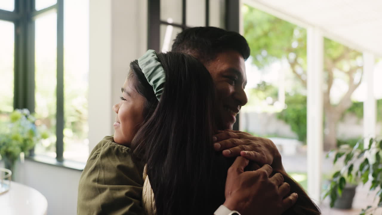 Affectionate Father and Daughter Hugging Indoors