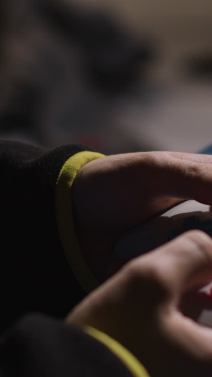 Vertical Video Close Up Hands Man Playing Video Game Controller Sitting Sofa At Home 3