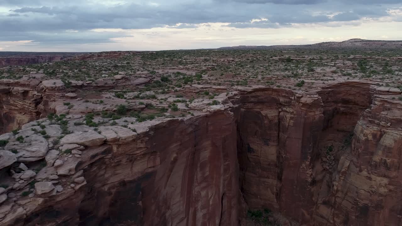 A 4K rotating drone shot of the "Fruit Bowl", a famous highlining area found deep in the heart of Moab’s share of the Colorado Plateau, along a remote section of Mineral Canyon, in Utah