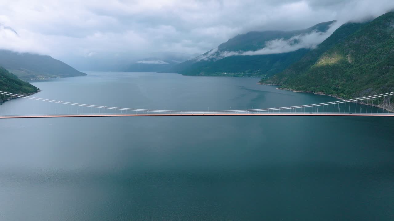 Hardanger bridge and Hardangerfjord in Norway on cloudy rainy day, drone push out