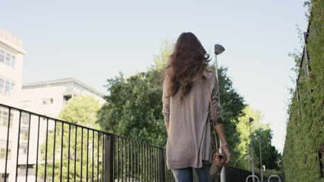 beautiful woman walking through urban city streets