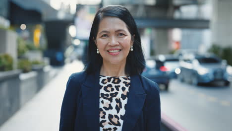 smiling business woman in city street
