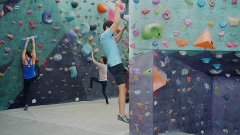 people rock climbing on indoor bouldering wall