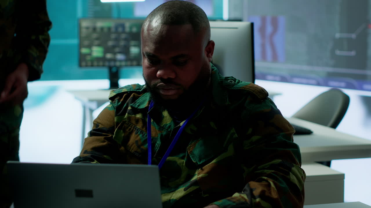 IT analyst in a high tech base of operations handling surveillance activity