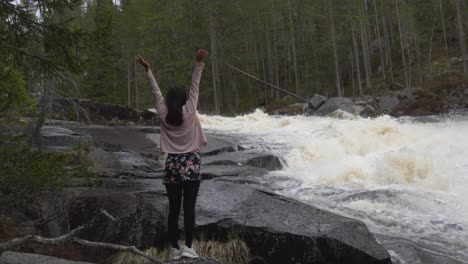 girl enjoys herself by a beautiful river