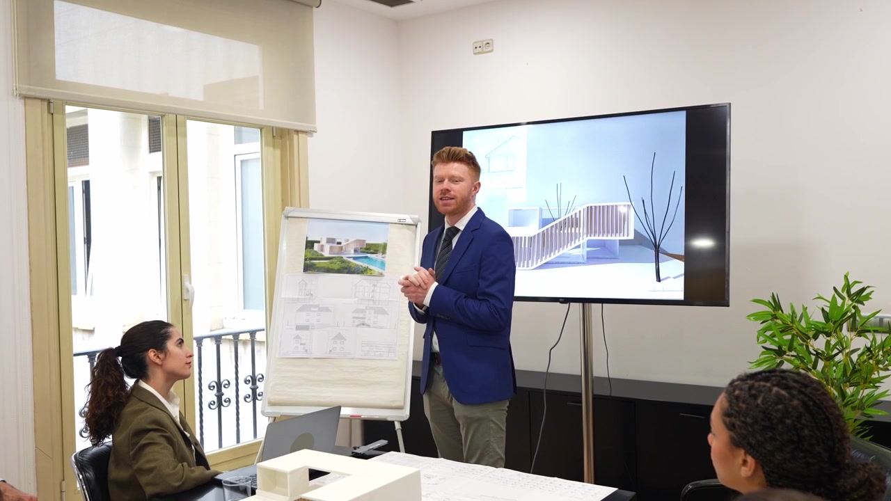 Architect Presenting Architectural Designs to Colleagues in Office Meeting