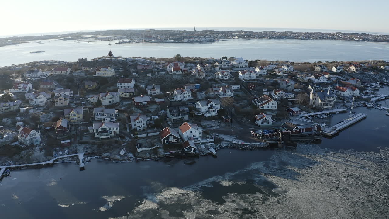 Aerial shot of a small town with small houses on rocky islands on a sunny winter day at Öckerö Island Municipality in Gothenburg archipelago, Sweden.