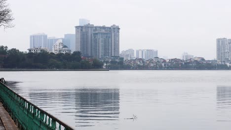 calm lake with cityscape in the background