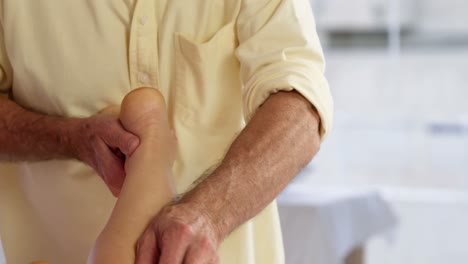 Female-patient-receiving-leg-massage-from-male-physiotherapist