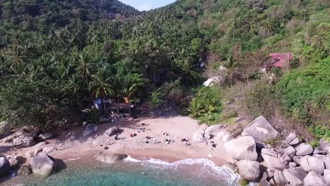 people collecting trash on beach camera point slowly down while drone fly forward back above water 1080 hd asia, thailand filmed with sony ax700