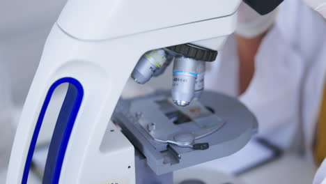 scientist, microscope and analysis of sample