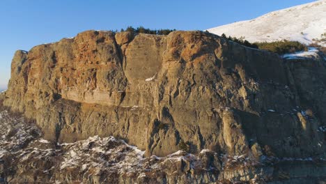 winter mountain landscape with rocky cliff