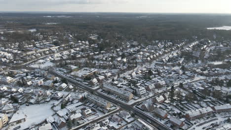 aerial overview of small rural town in winter - drone flying backwards