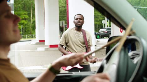 musician playing in a gas station