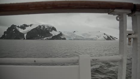 artistic shot of antarctica coast line with snow and ice covered mountain range