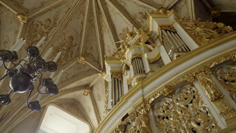 close-up of historic organ in a castle chapel, with a classic chandelier in the foreground
