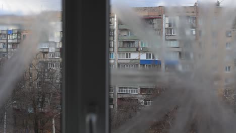 in kramatorsk, ukraine, a window taped for protection offers a grim view of civilian life. this scene underscores the constant threat and urban impact of the ongoing ukraine-russia war.