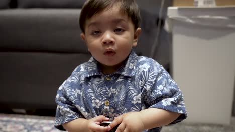 Indian-baby-Sat-On-Floor-Holding-Computer-Mouse