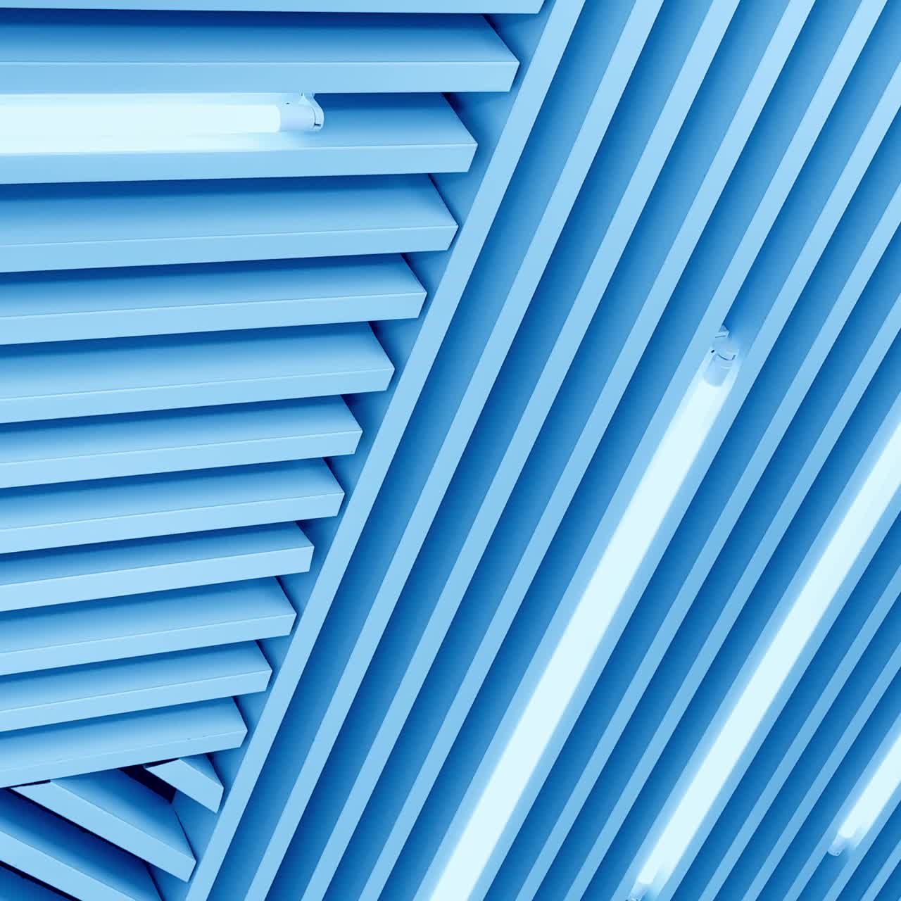 Decorative panels on the ceiling with long led lamps. Switched on illumination of white light. Low angle view