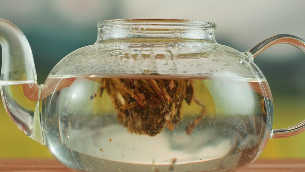 Blooming Tea Infusing in a Clear Glass Teapot