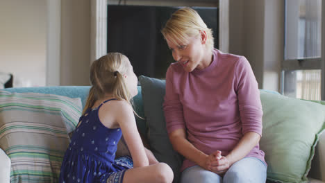 caucasian woman talking with her daughter at home