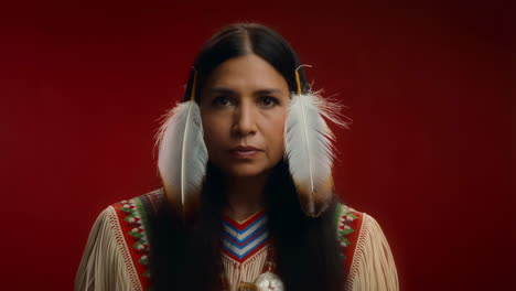 portrait of an indigenous woman with feathers and traditional attire