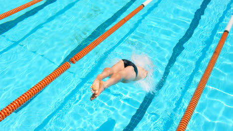 male swimmer jumping into swimming pool 4k