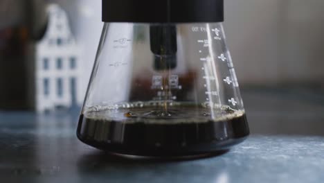 Coffee-dripping-from-V60-into-carafe-or-glass-jug