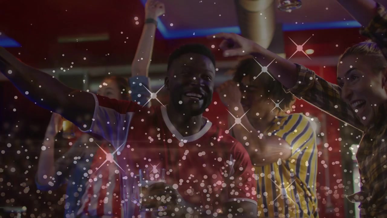Friends at bar reacting to sports TV, cheering and raising drinks as sparkle overlay covering faces