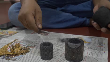 Selective-focus-of-an-Indian-goldsmith-preparing-to-melt-gold-jewelry-in-a-workshop