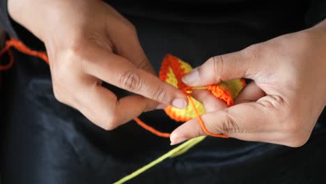 crocheting with orange and yellow yarn