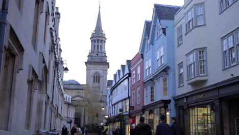 exterior of shops and church in oxford city centre at dusk