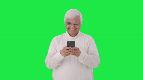 Happy-Indian-old-man-chatting-on-phone-Green-screen