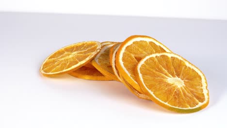thin dried slices of orange fruit dynamic slider shot against white