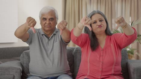 Disappointed-Indian-old-couple-showing-thumbs-down