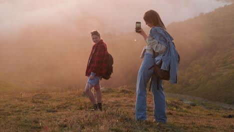 two women hiking in the mountains at sunset