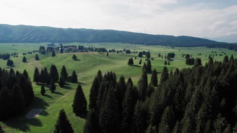 drone flying over a mountain plateau and over a golf course in the italian alps