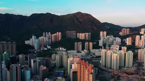 colourful sunrise coloured aerial view above kowloon city high rise towers and mountain peak skyline hong kong